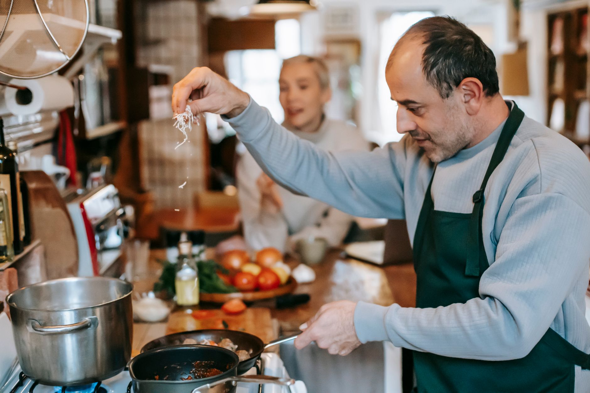 man preparing food on stove for lunch